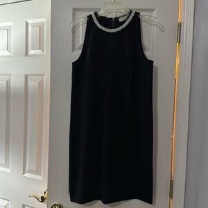 Black ladies dress with pearl
Neckline size 6.